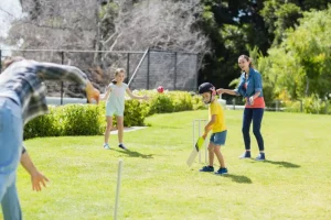 Family playing cricket together